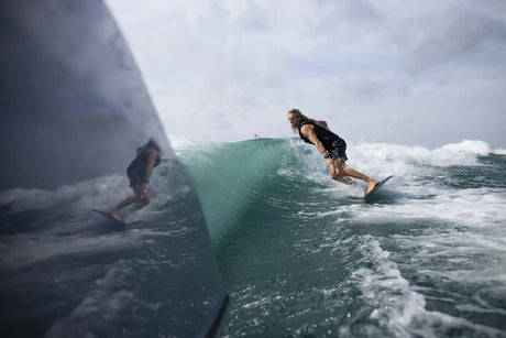 Man surfing behind a boat